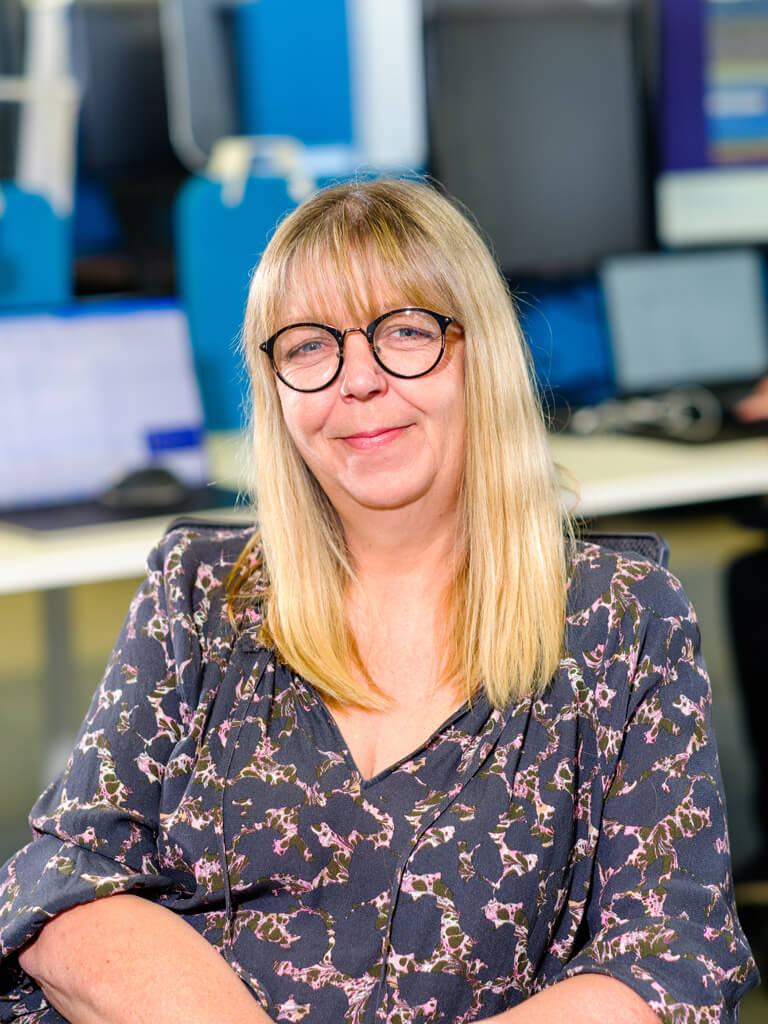 Female Resolute Cyber team member smiling in a professional office setting